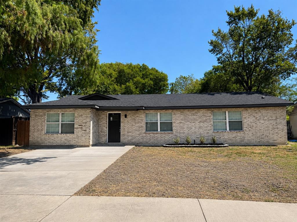 Brick exterior with dark roof shingles, an integrated entryway, and a concrete driveway Brick exterior with dark roof shingles, an integrated entryway, and a concrete driveway
