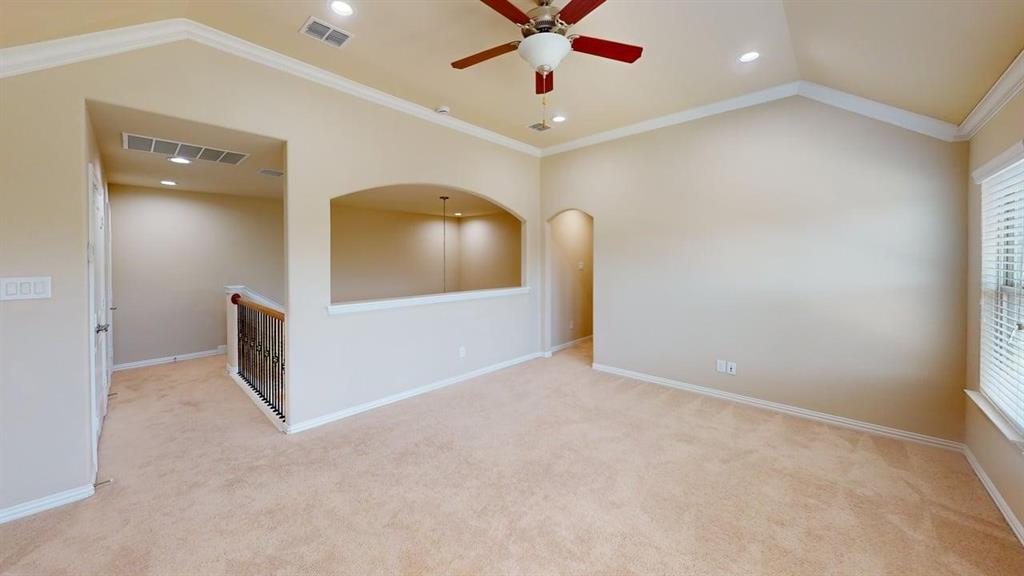 Vaulted ceiling with crown molding, recessed lighting, and a ceiling fan