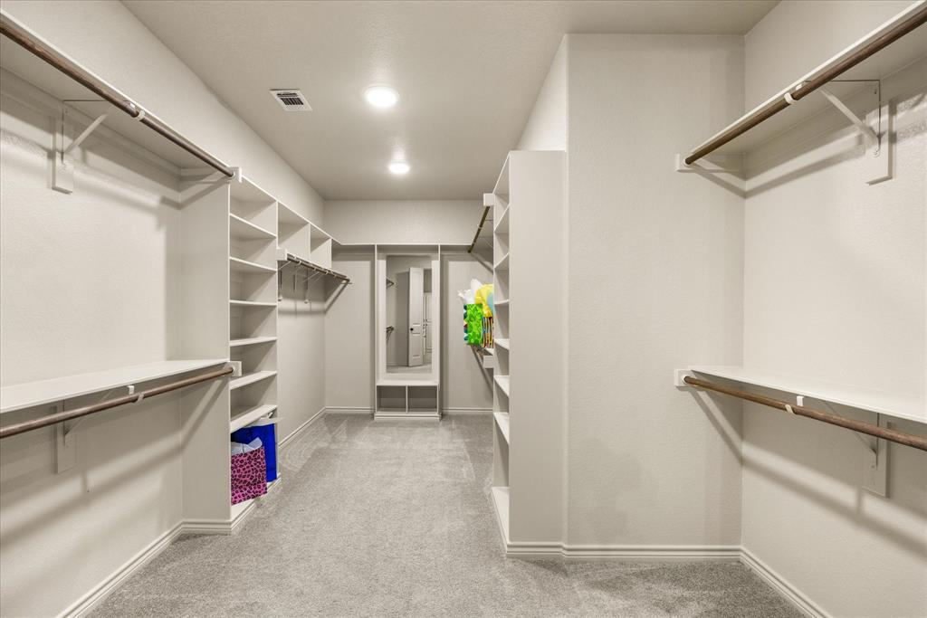 Primary closet with storage galore!!