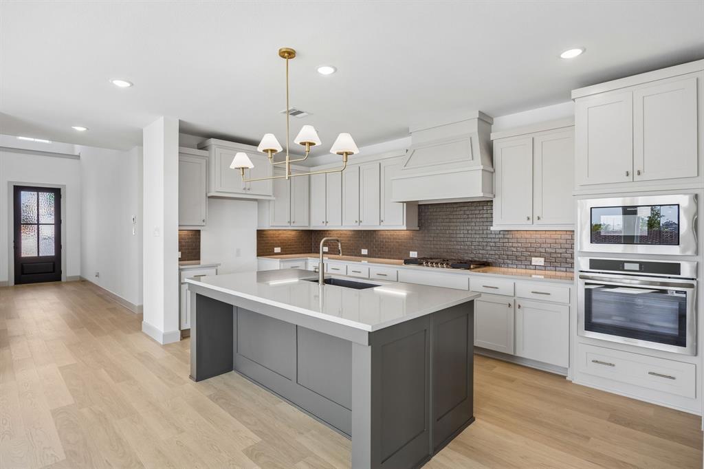 This brand new dream kitchen features gorgeous cabinetry, contemporary countertops, and stainless appliances.