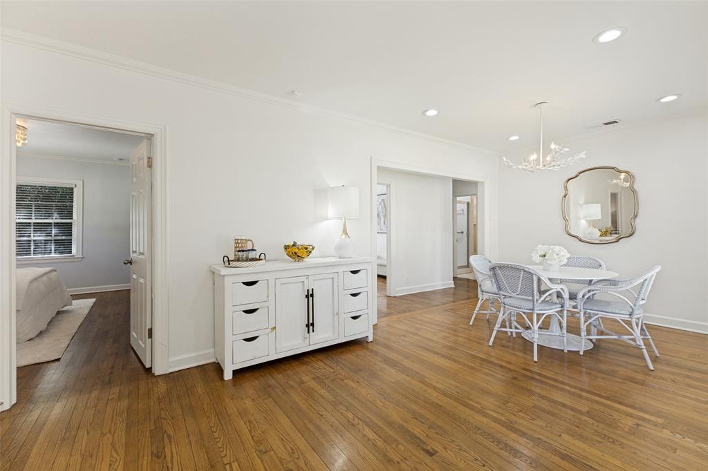 A peek into the primary bedroom on the left and additional bedrooms to the right.