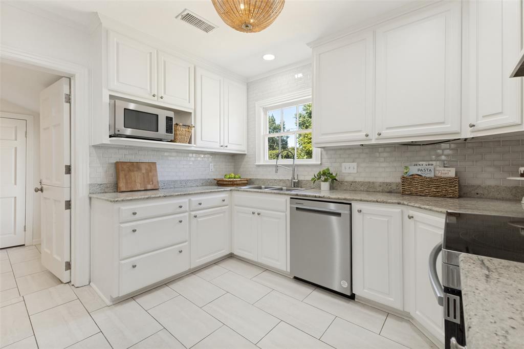 Stainless appliances and a kitchen faucet are recent additions to this well-appointed kitchen with ample storage.