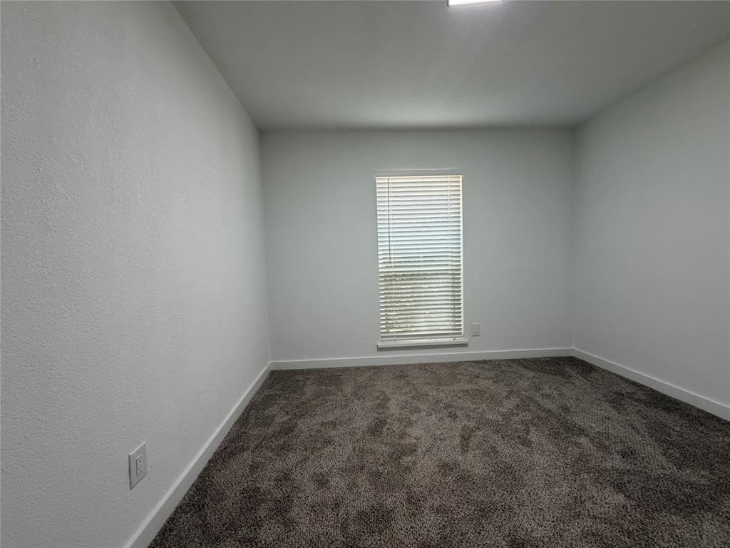 Window with horizontal blinds, textured walls, wall-to-wall carpeting, and recessed ceiling lighting