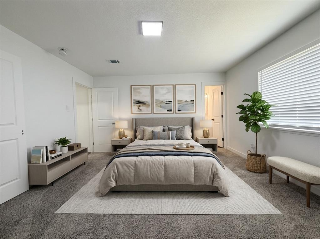Staged- Spacious room with gray carpet flooring and a rectangular window with blinds