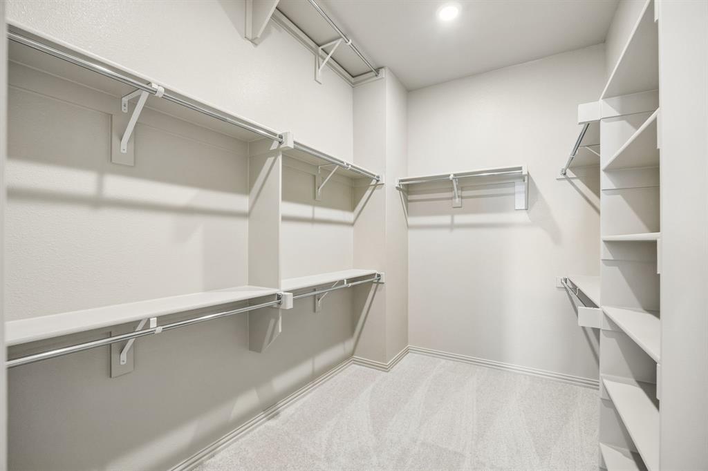 Featuring seasonal hanging rods and plenty of space to spread out, your dream owner's closet awaits!