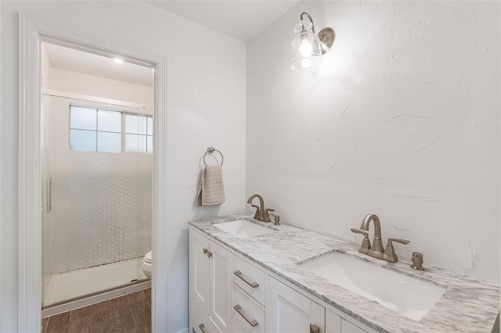 Double vanity with undermount sinks and light-colored countertop