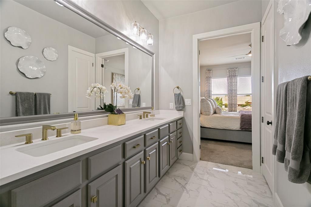 Primary Bathroom includes an oversized walk-in closet with a custom system.