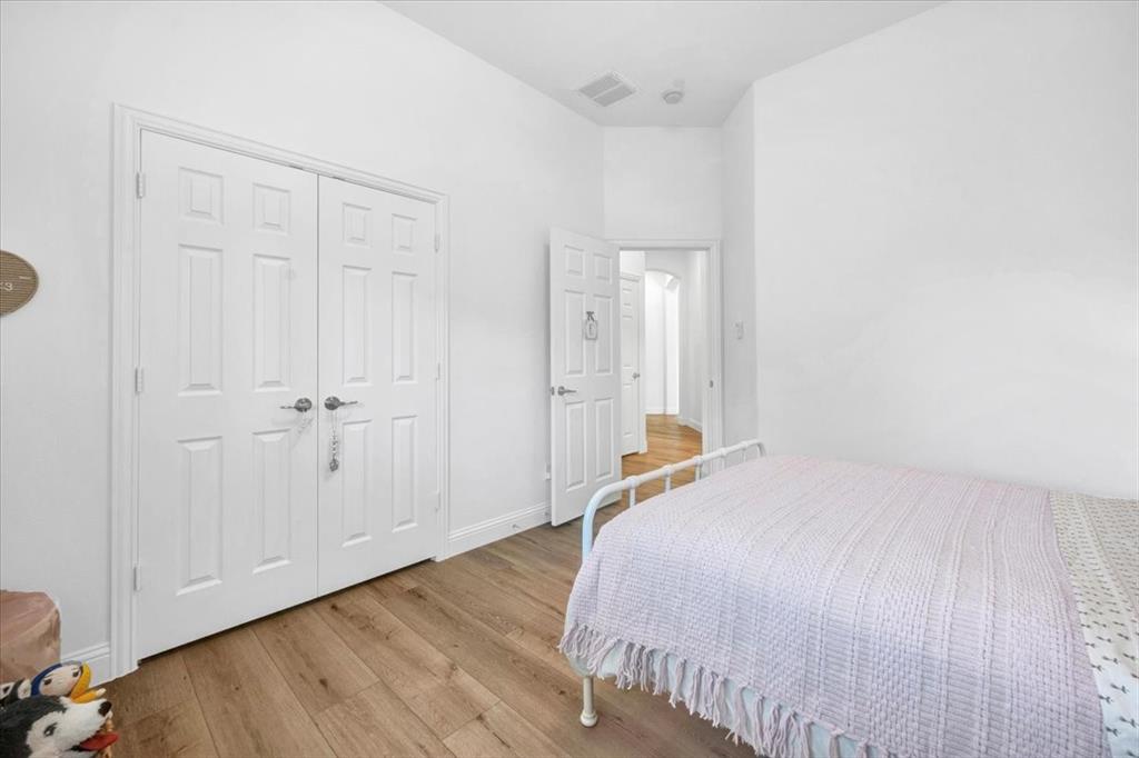 Wood-finish flooring complemented by light-toned walls and white trim