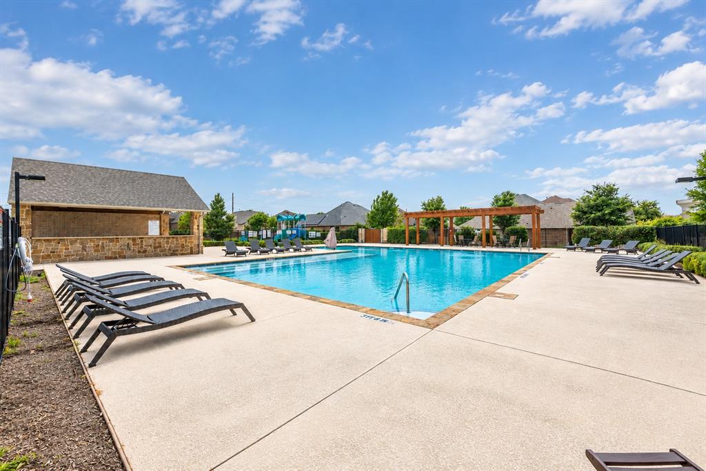 Expansive outdoor swimming pool with surrounding concrete decking
