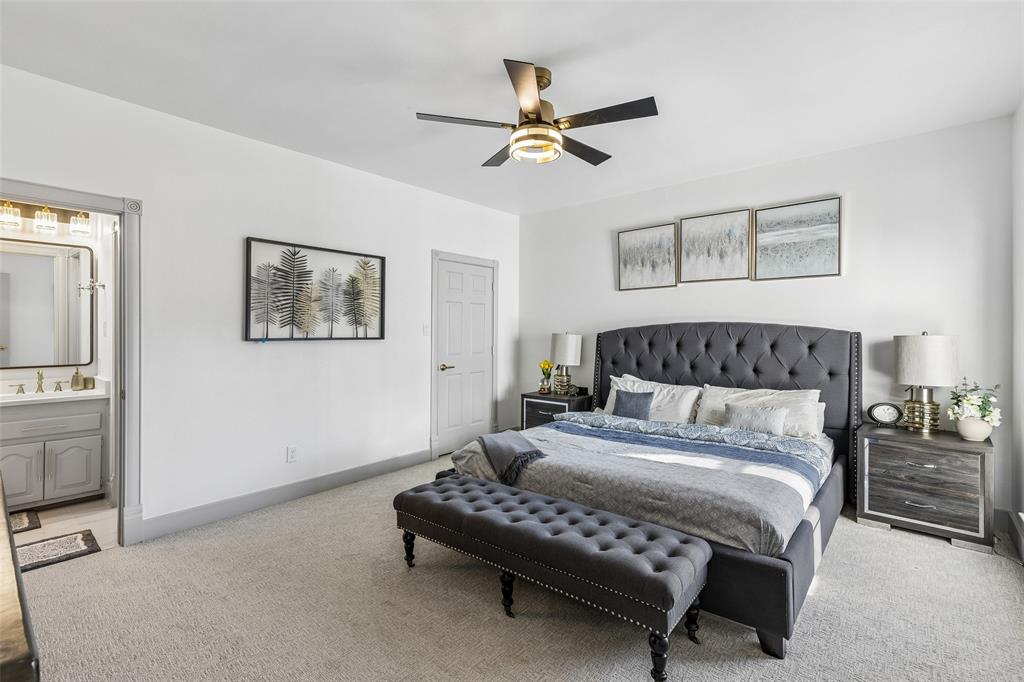 Plush carpet flooring, a contemporary ceiling fan, and a neutral wall color define this space