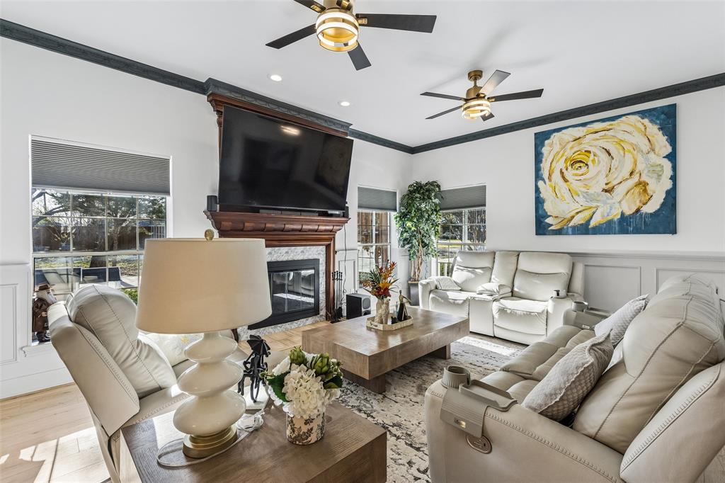 Wood-finish flooring, recessed lighting, and crown molding