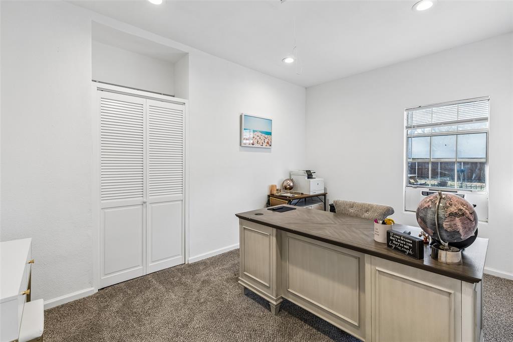 Recessed lighting, window with blinds, louvered bi-fold doors, white walls, and carpet flooring