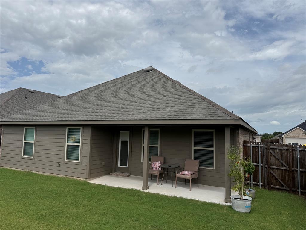 Covered patio with concrete flooring, shingle roof, and durable siding