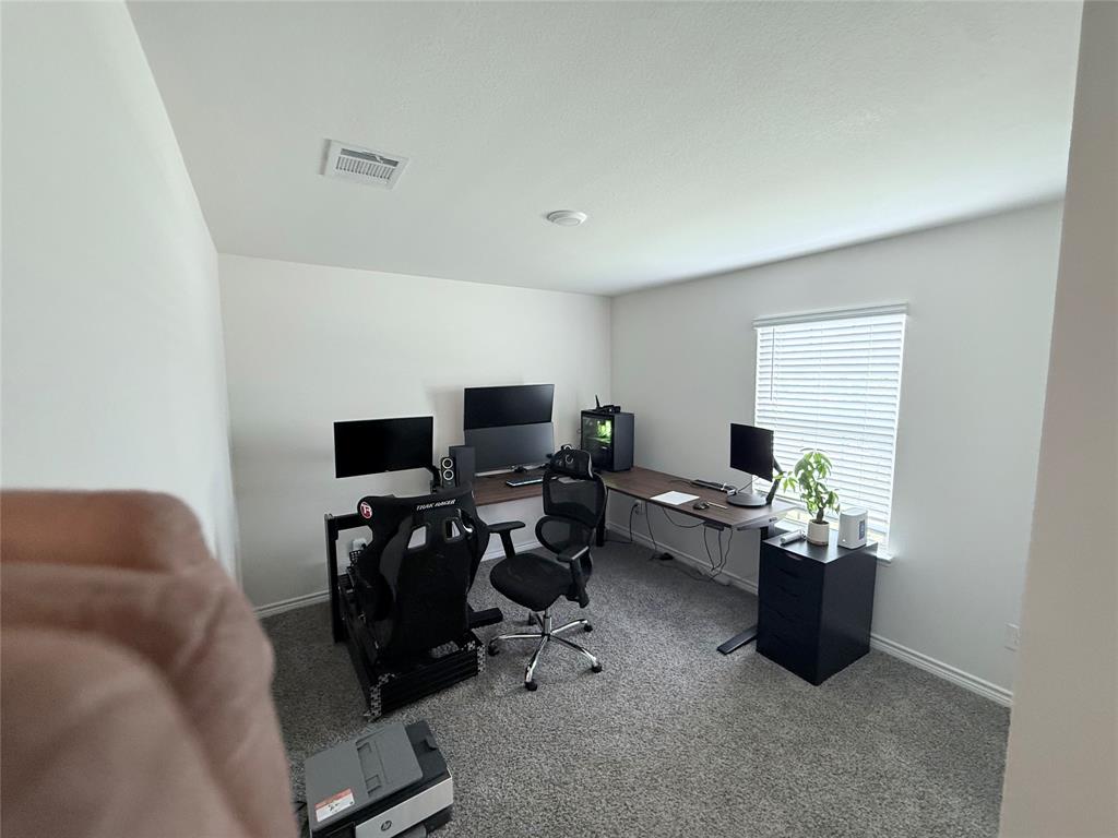 Carpeted flooring, white painted walls, and a window with blinds