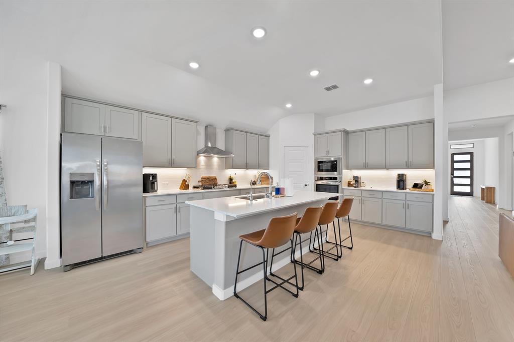 Another view of the kitchen with a large center island for extra seating.