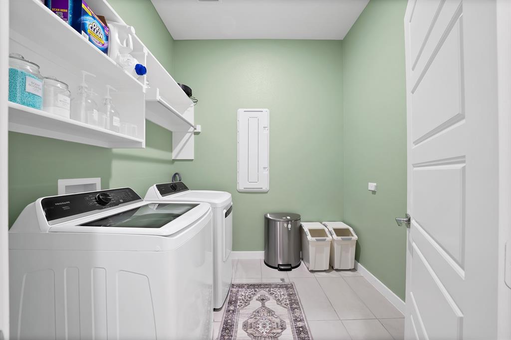 Laundry room with W/D hook ups, shelves and a drying rack.
