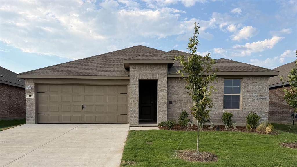 Brick exterior with a gabled roof and attached two-car garage