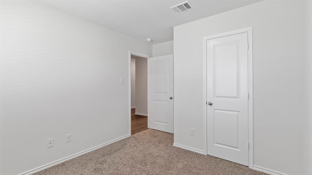 Light-colored carpeting, white interior doors, and a white ceiling