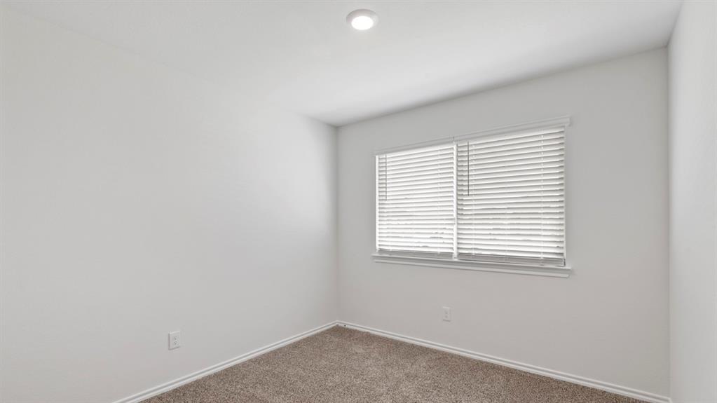 Recessed ceiling light, neutral wall paint, window with blinds, and carpeted flooring