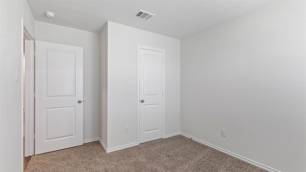 Neutral paint palette, textured carpet flooring, white trim, recessed lighting, white panel doors