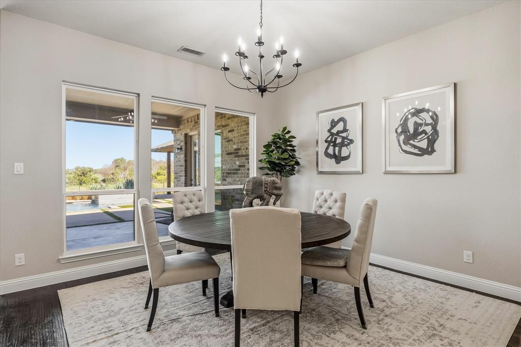 Multiple large windows, dark wood-finish flooring