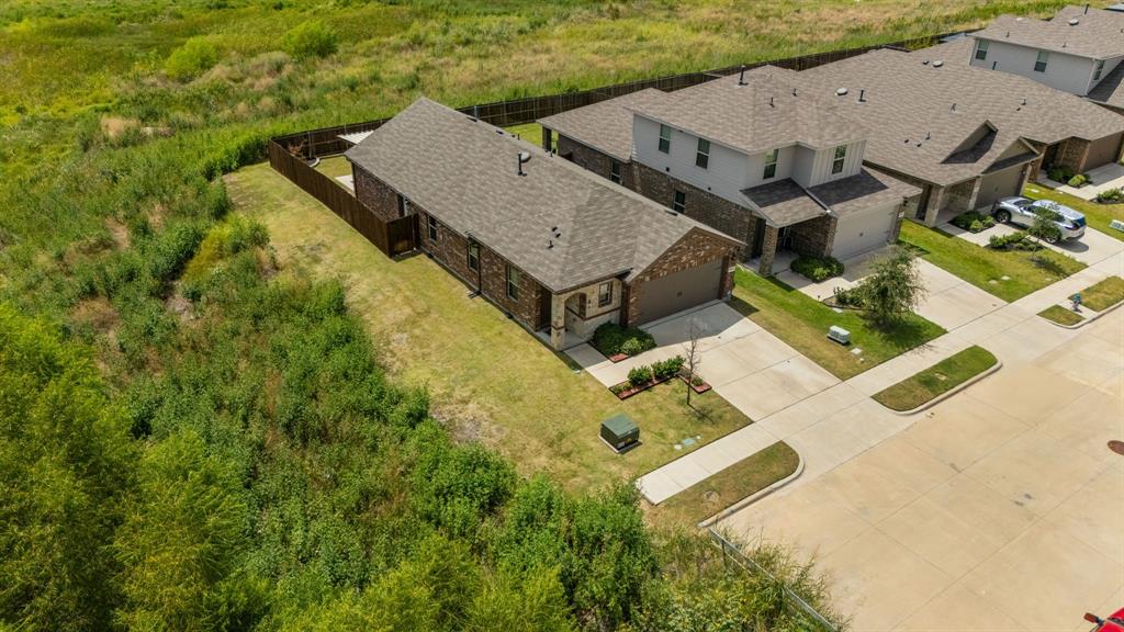 Single-story residence with brick and siding exterior, attached garage, and a fenced backyard