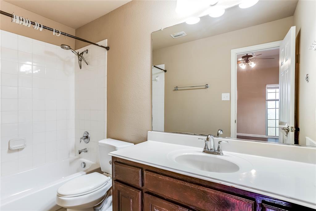 White tile shower surround with a chrome shower head and faucet