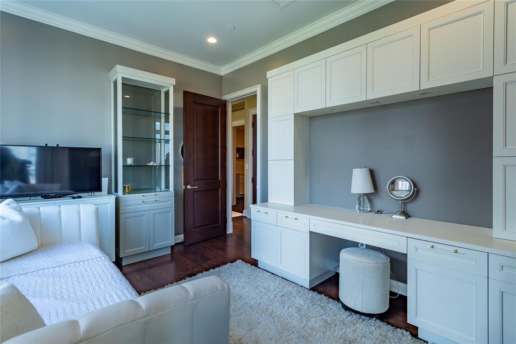 Study has a wall of built-ins and a pop-up TV.