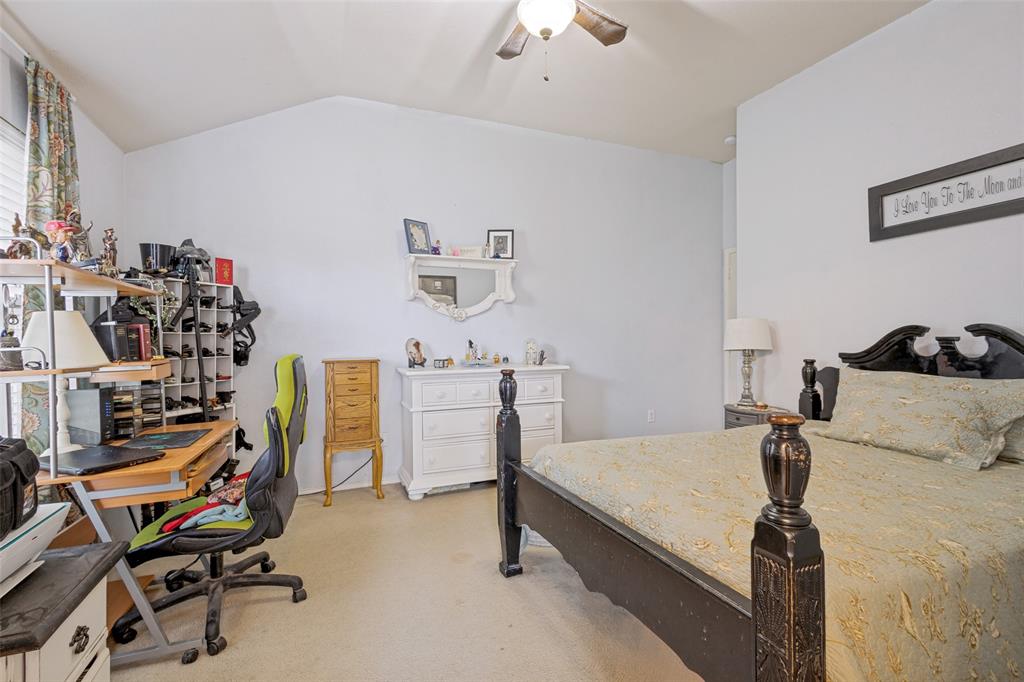 Vaulted ceiling and light paint welcome you into the primary bedroom.