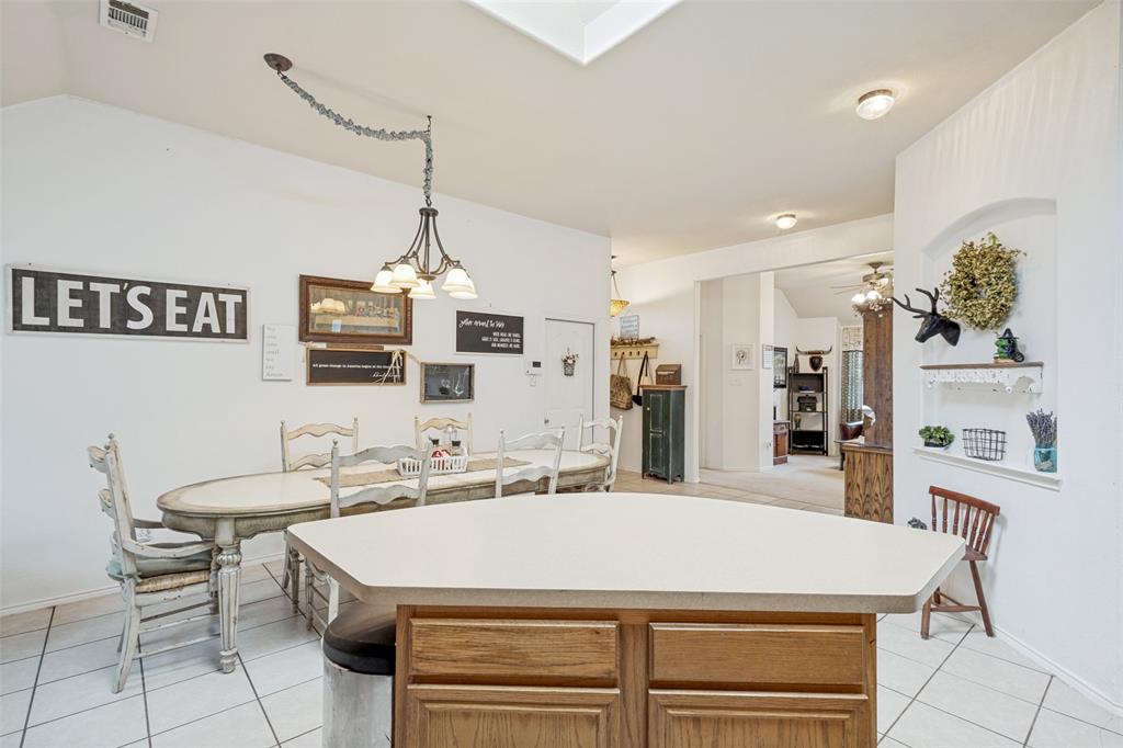 Kitchen island with light-toned countertop and wood-finish cabinetry
