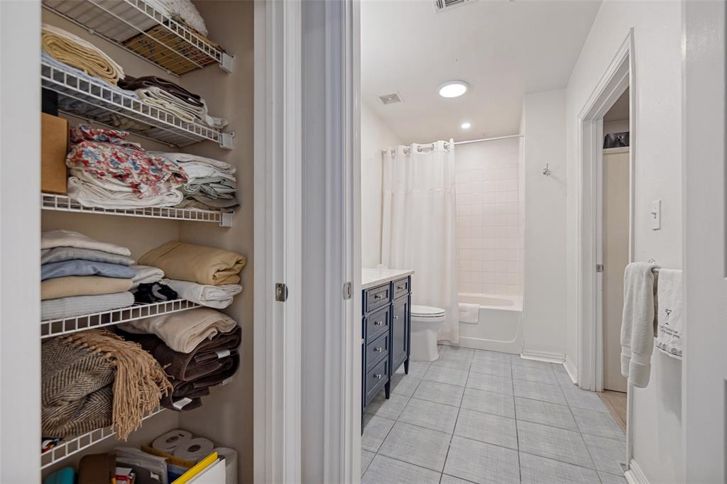 Linen closet & oversized master closet with custom closet system.