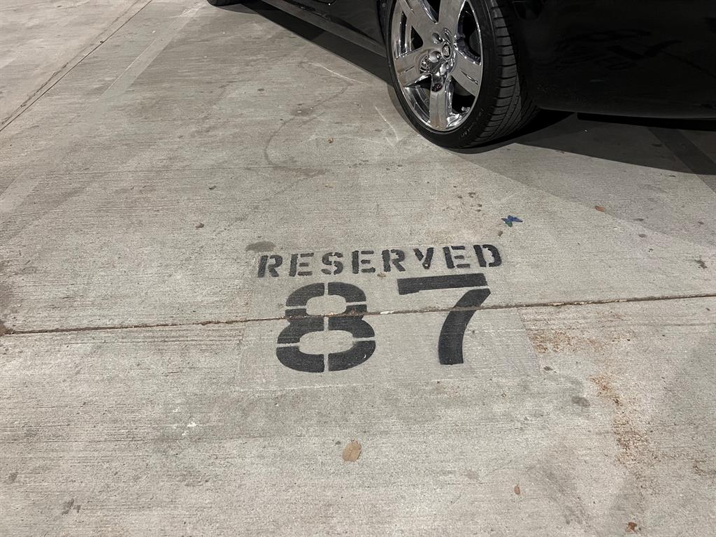 End parking spot in the gated garage parking and side-by-side assigned spots.