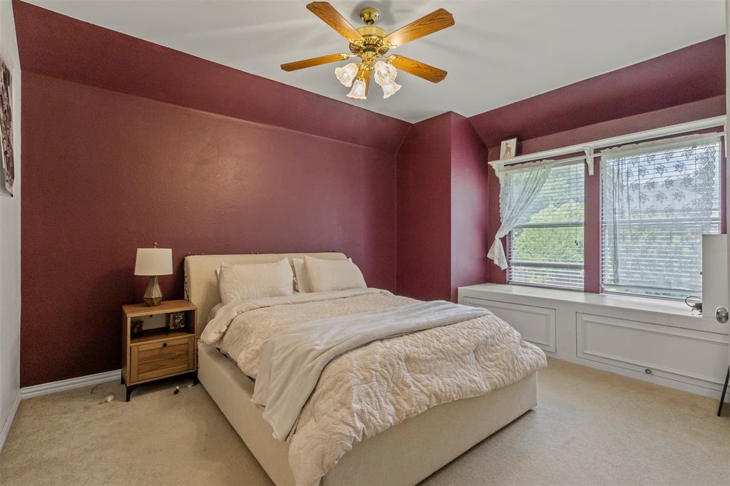 Ceiling fan with light fixture, dual windows, built-in window seating, and wall shelving