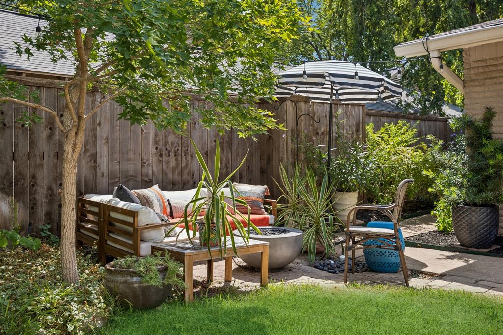 Grassy yard area with a privacy fence and mature landscaping
