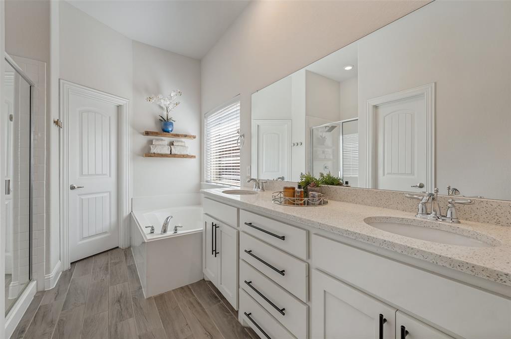 Dual vanity with integrated sinks, light-toned countertop, and dark hardware