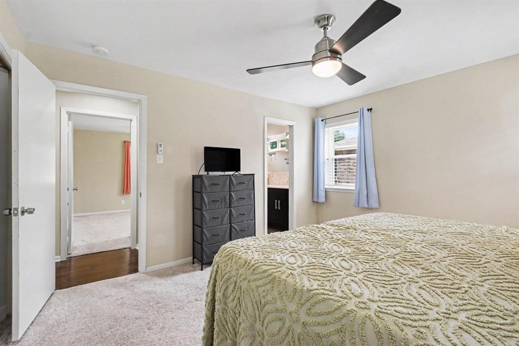 Recessed window with blinds, ceiling fan with integrated lighting, and neutral wall paint