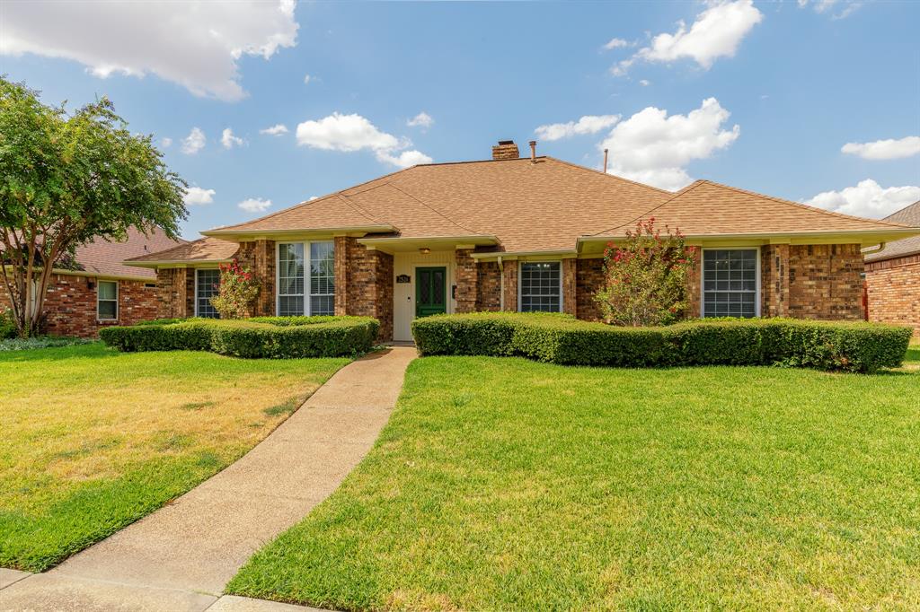 Brick exterior with a gabled roof and covered entry
