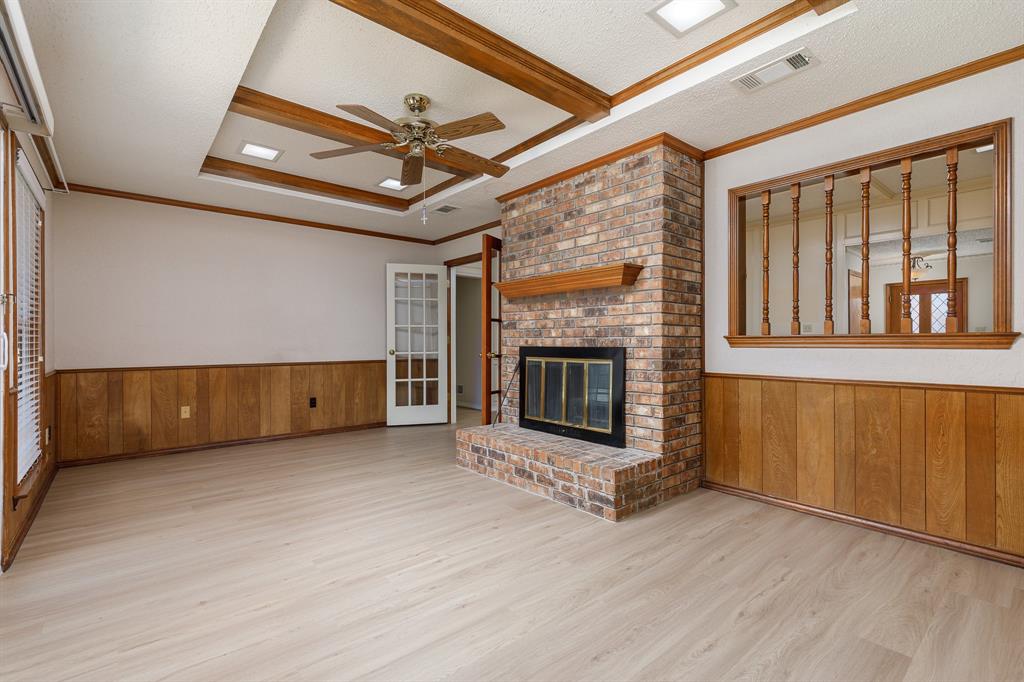 Brick-faced fireplace with a wood mantel