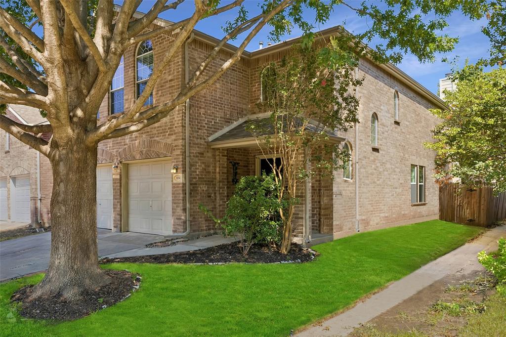 Brick exterior featuring a covered entry and arched windows