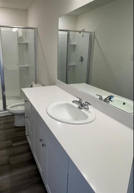 White vanity with an integrated sink, chrome faucet, and expansive wall-mounted mirror