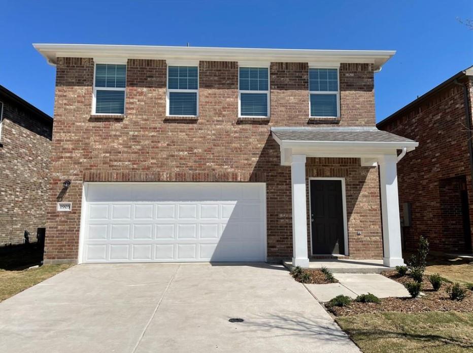 Brick facade, white trim, covered front entry, attached garage, and concrete driveway