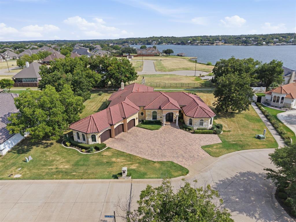 Mediterranean-style residence with a red tile roof and light-colored stone exterior