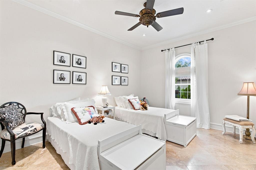 Recessed lighting, crown molding, arched window with white curtains, ceiling fan, and tiled flooring