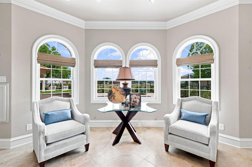 Arched windows with grid panes, crown molding, and recessed lighting