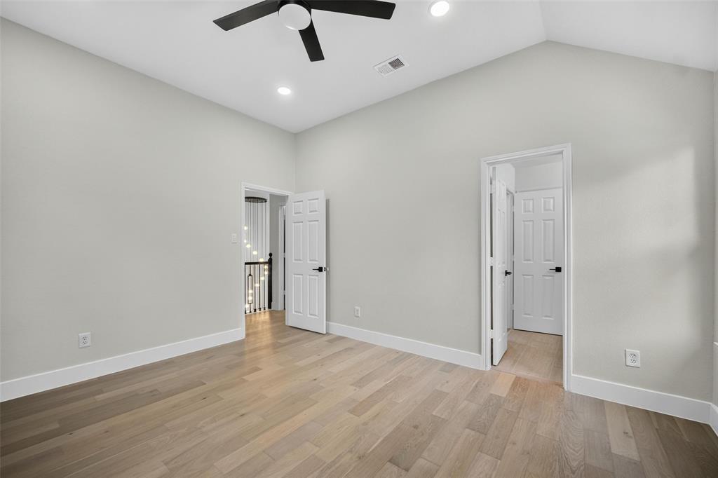 Vaulted ceiling with a ceiling fan, light wood-finish flooring, recessed lighting, and white trim