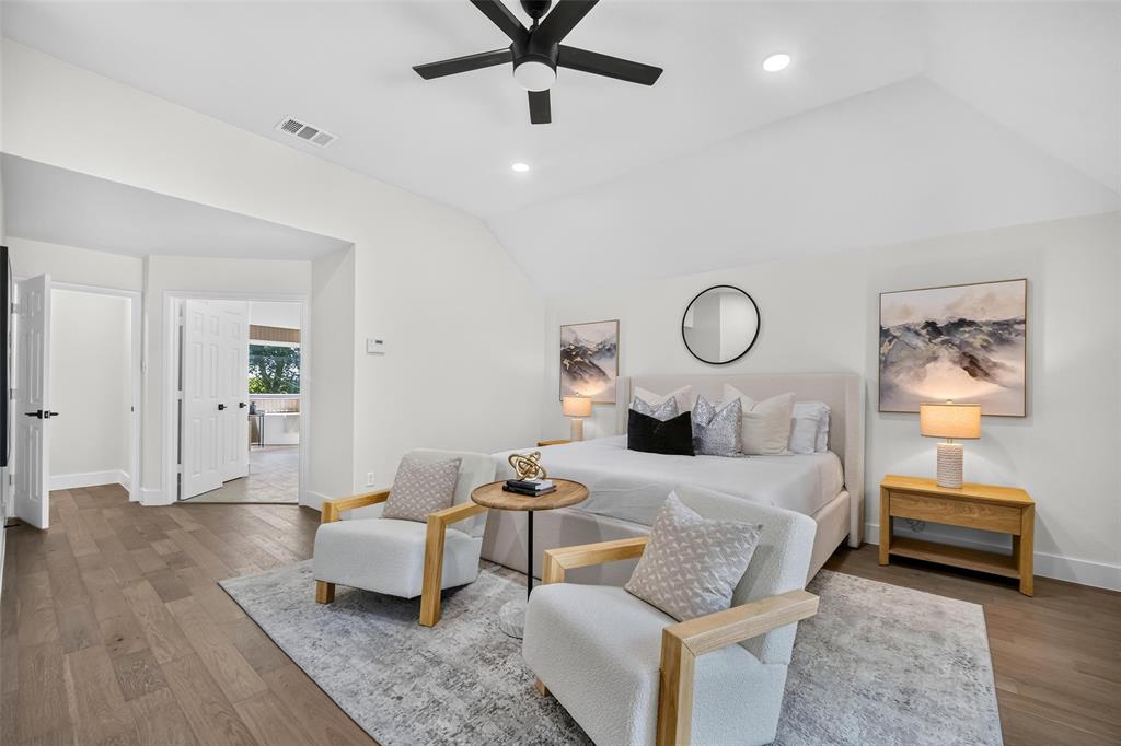 Vaulted ceiling with recessed lighting, wood-finish flooring, white paneled doors, and a ceiling fan with integrated lighting