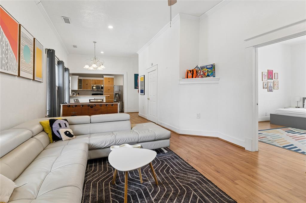 Hardwood flooring throughout, crown molding, and recessed lighting
