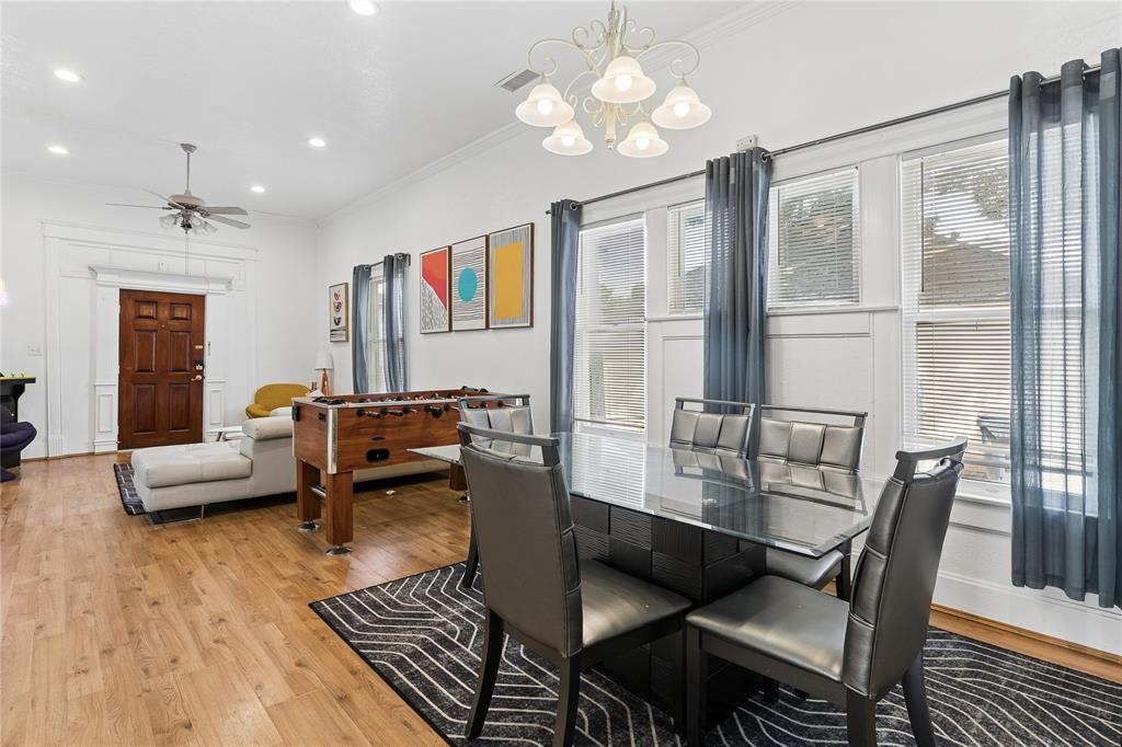 Open-concept living area featuring wood-finish flooring, recessed lighting, and a decorative ceiling fan