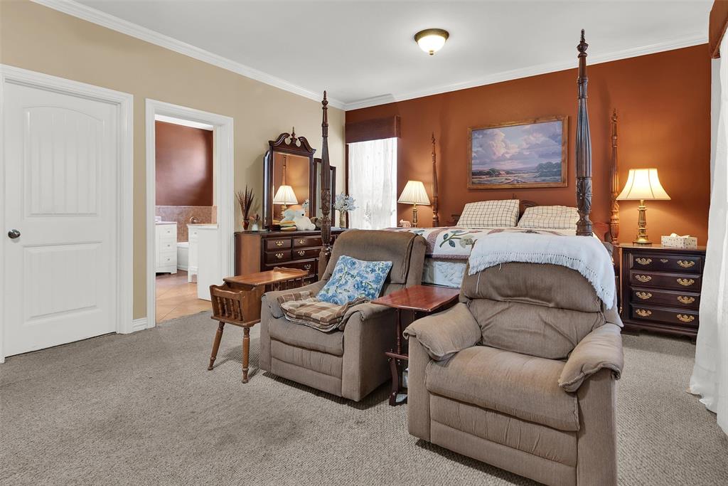 Warm-toned accent wall, carpeted flooring, and a white six-panel door with an arched top panel