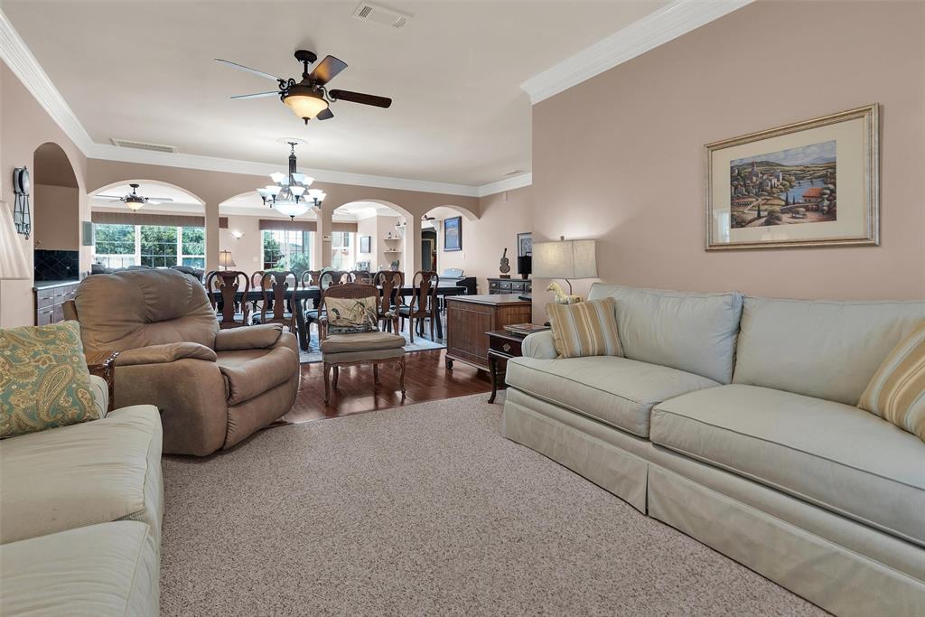 Recessed ceiling fan, crown molding, arched entryways, wood-finish flooring, and light carpeting Recessed ceiling fan, crown molding, arched entryways, wood-finish flooring, and light carpeting